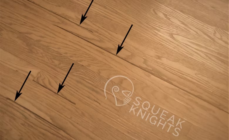 Hardwood floorboards with missing and splintered pieces